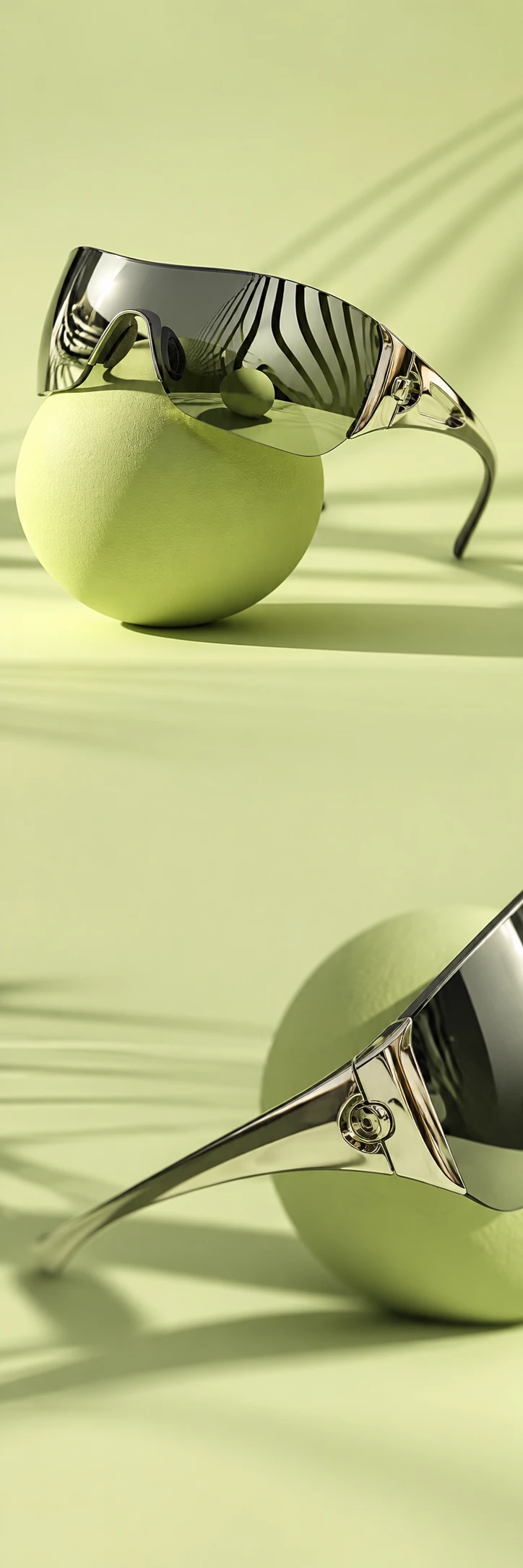 Experimental premium eyewear campaign: large sculptural mirror chrome wraparound sunglasses at a dramatic angle on a pale lime green sphere, reflections of wavy black architectural lines, crisp smoky glass, lens distortion. Lower scene a closeup of silver hinge and lime sphere shadow. Continuous very pale lime matte studio space with quiet copy zones, precise optical art photography, no text.